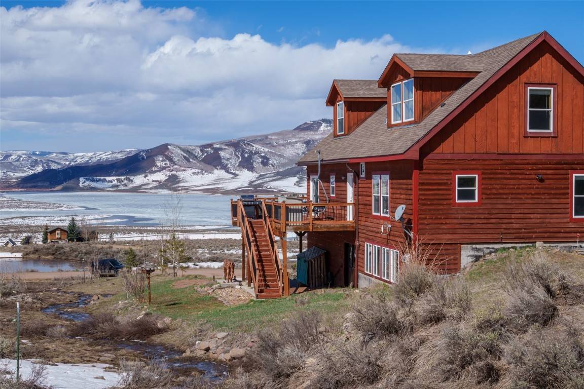 Nestled on the shores of a tranquil lake, this charming chalet style home offers a picturesque retreat with breathtaking views of Stagecoach Reservoir and the proposed ski area.