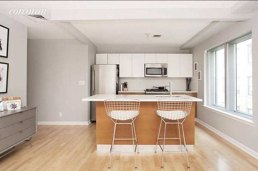 Oversized corner unit with south and west exposures avaiable December 15th 2021 The modern and open kitchen includes stainless steel appliances and Caesarstone countertops and backsplashes.