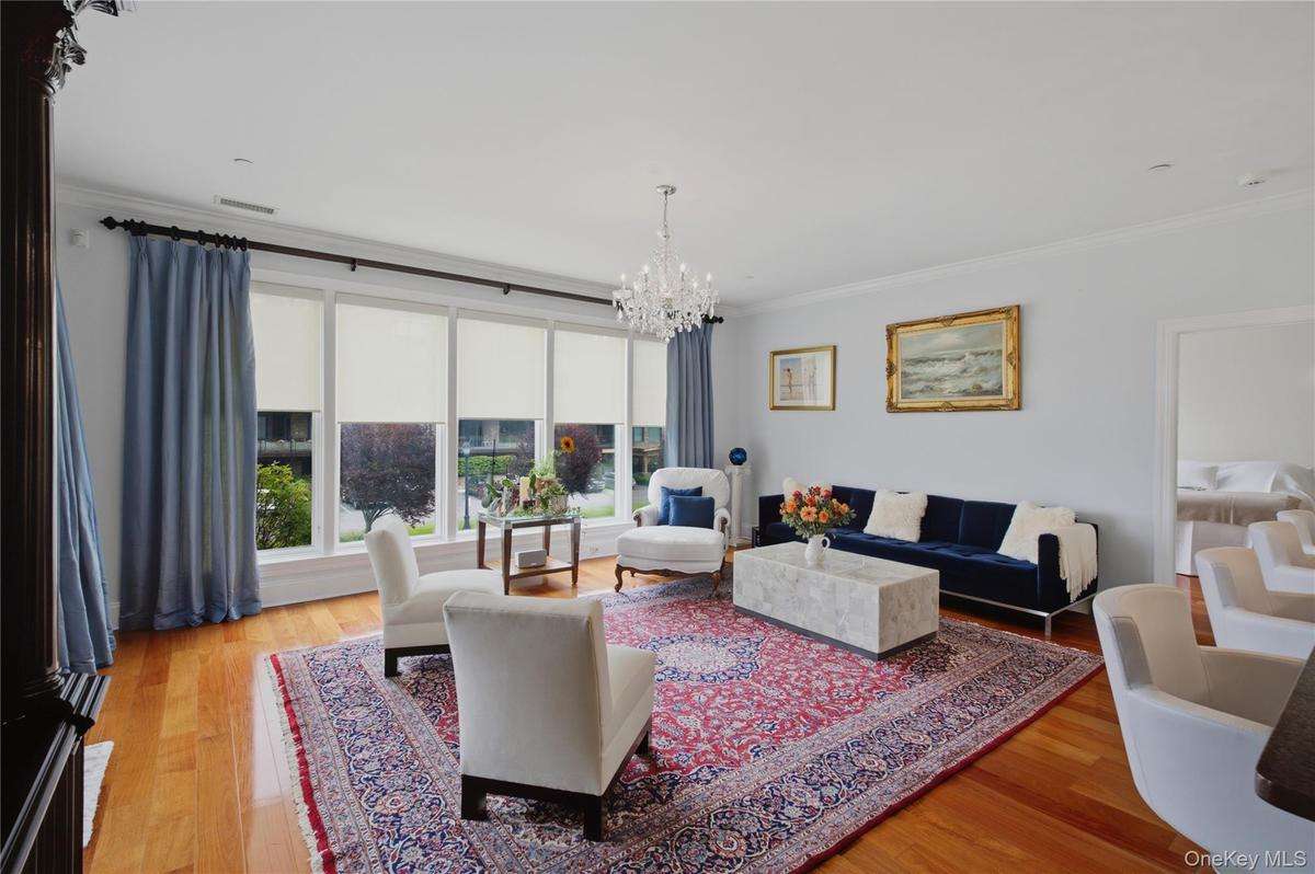 Spacious living room with beautiful large windows creating an airy, open atmosphere