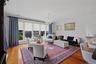 Spacious living room with beautiful large windows creating an airy, open atmosphere