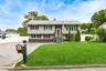 Hi Ranch residence featuring gray siding and dark window shutters