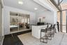Outdoor kitchen with granite counter and a half-bathroom