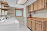 Laundry room with AC within the garage space