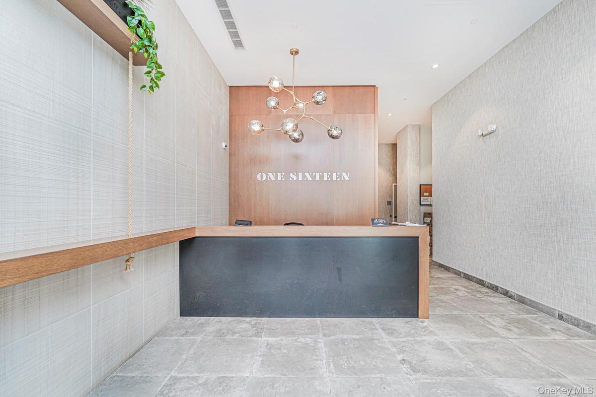 Reception area featuring a chandelier, wallpapered walls, and recessed lighting