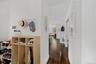 Corridor with dark wood-style flooring and baseboards
