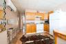 Kitchen featuring light hardwood / wood-style floors, a wall mounted air conditioner, sink, a drop ceiling, and white appliances