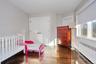 Bedroom featuring radiator, a closet, and dark wood-type flooring