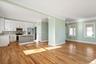 Unfurnished living room with crown molding, light wood finished floors, and recessed lighting