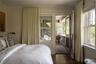 Bedroom featuring dark wood-style flooring and crown molding