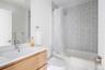Bathroom featuring toilet, shower / tub combo, and vanity