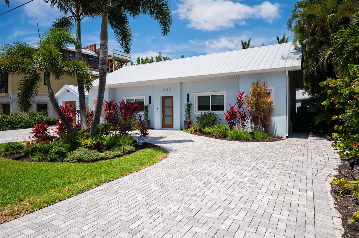 The brick paver circular driveway allows for plenty of parking