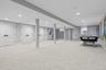 Below grade area with light colored carpet and recessed lighting