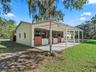 Well-maintained horse barn featuring spacious stalls and a covered work area.