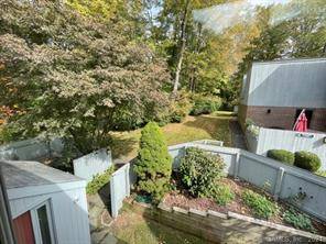 Sun filled upper level condo with private garden area with beautiful secluded wooded views.