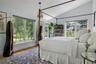 Vaulted ceiling with dual-aspect windows overlooking the gardens