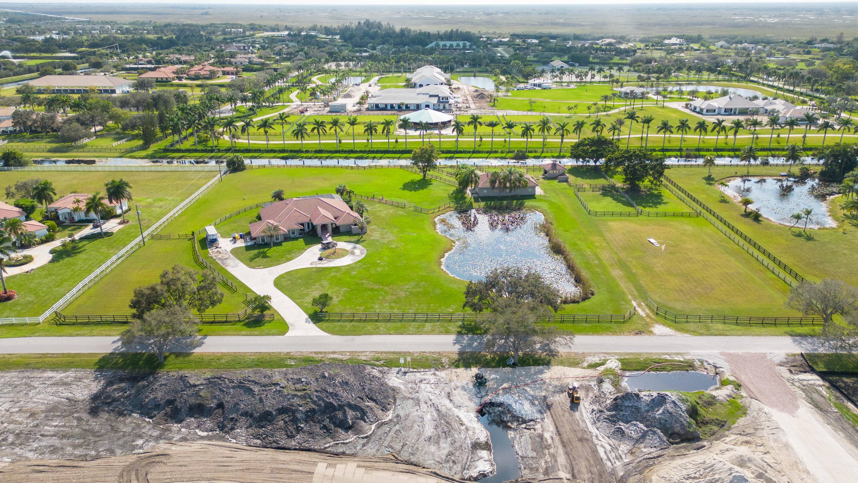 This beautiful horse property boasts an idyllic location on over 5 acres in the coveted equestrian community of Palm Beach Point.