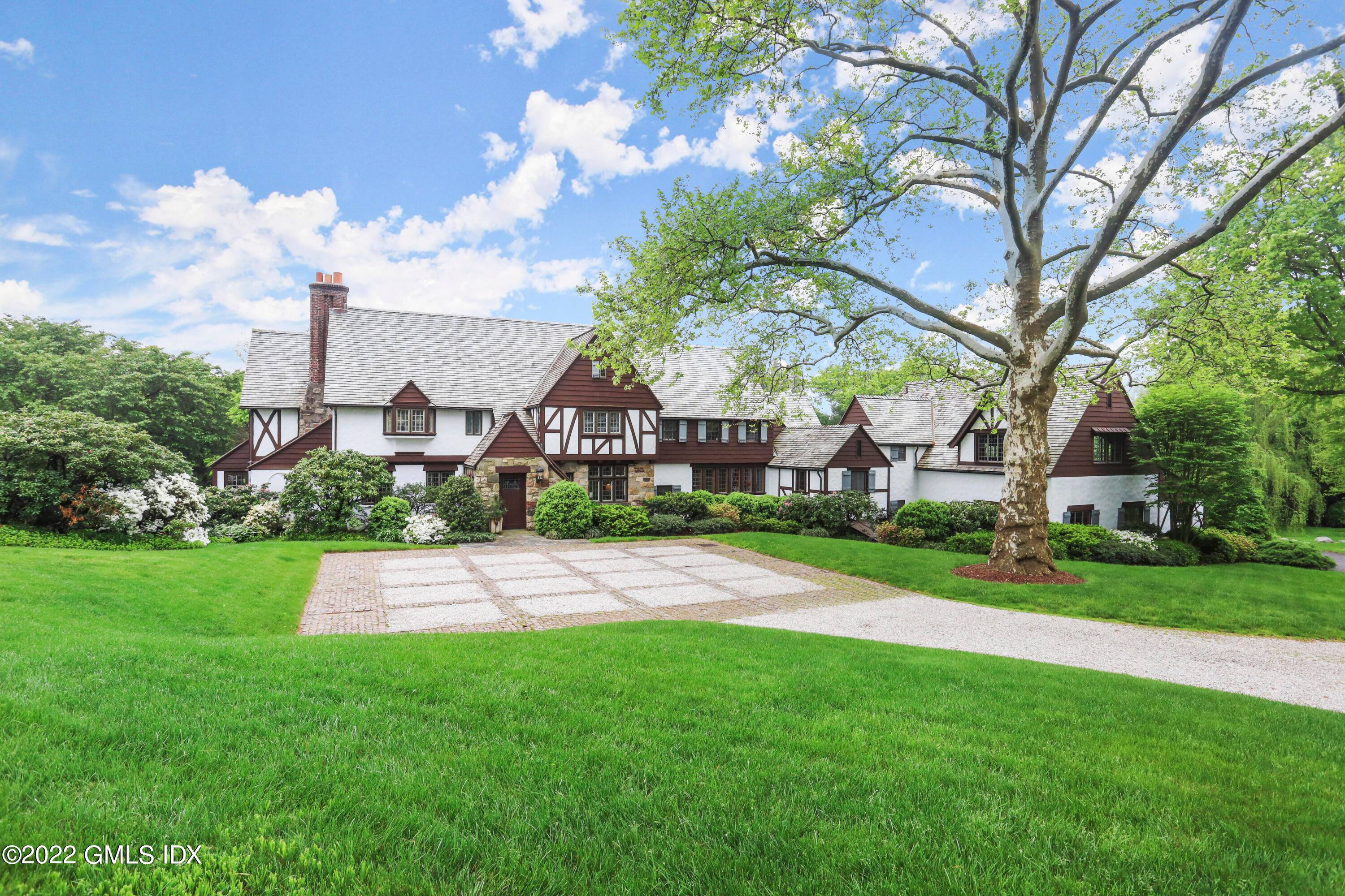 Belle Haven Peninsula Exquisite architectural details combined with modern updates characterize this charming six bedroom English Manor set back on 1.