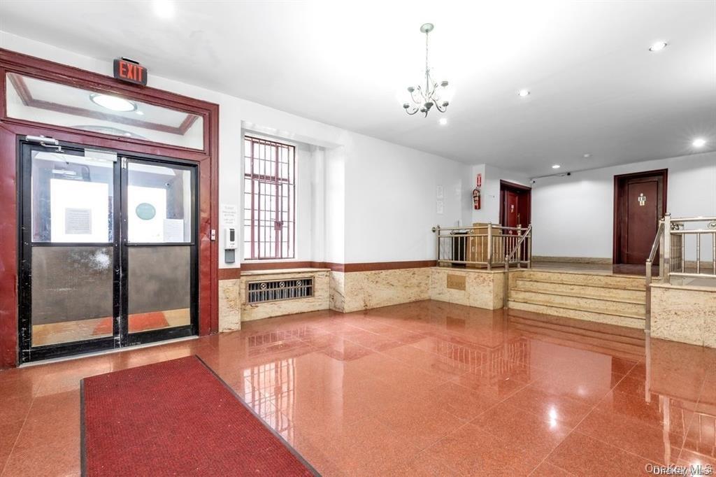 Community lobby with recessed lighting, stairs, wainscoting, and tile walls