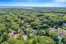 Aerial view of residential area with property parcel outlined and a nearby body of water