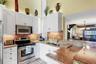 Spacious Kitchen with White Cabinetry, SS Appliances, and Granite Countertops