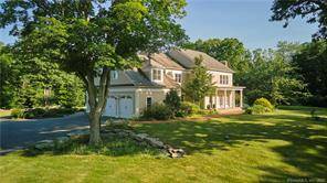 Custom designed farmhouse with impeccable design that is perfectly sited in on a verdant 10 acre private lot in sought after Lyme, CT.