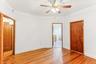 Unfurnished bedroom featuring light wood finished floors and ceiling fan