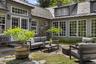 A beautifully landscaped stone courtyard, offering a secluded outdoor setting for entertaining and quiet relaxation