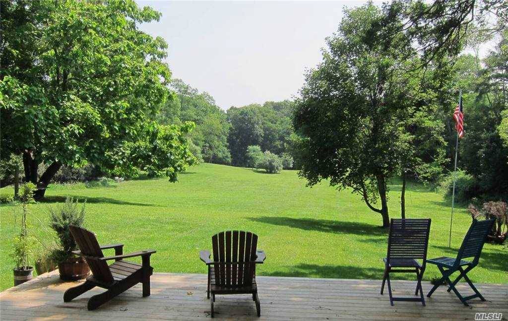 A wonderful 1800s farmhouse that is situated on nearly three acres of pristine rolling lawn.