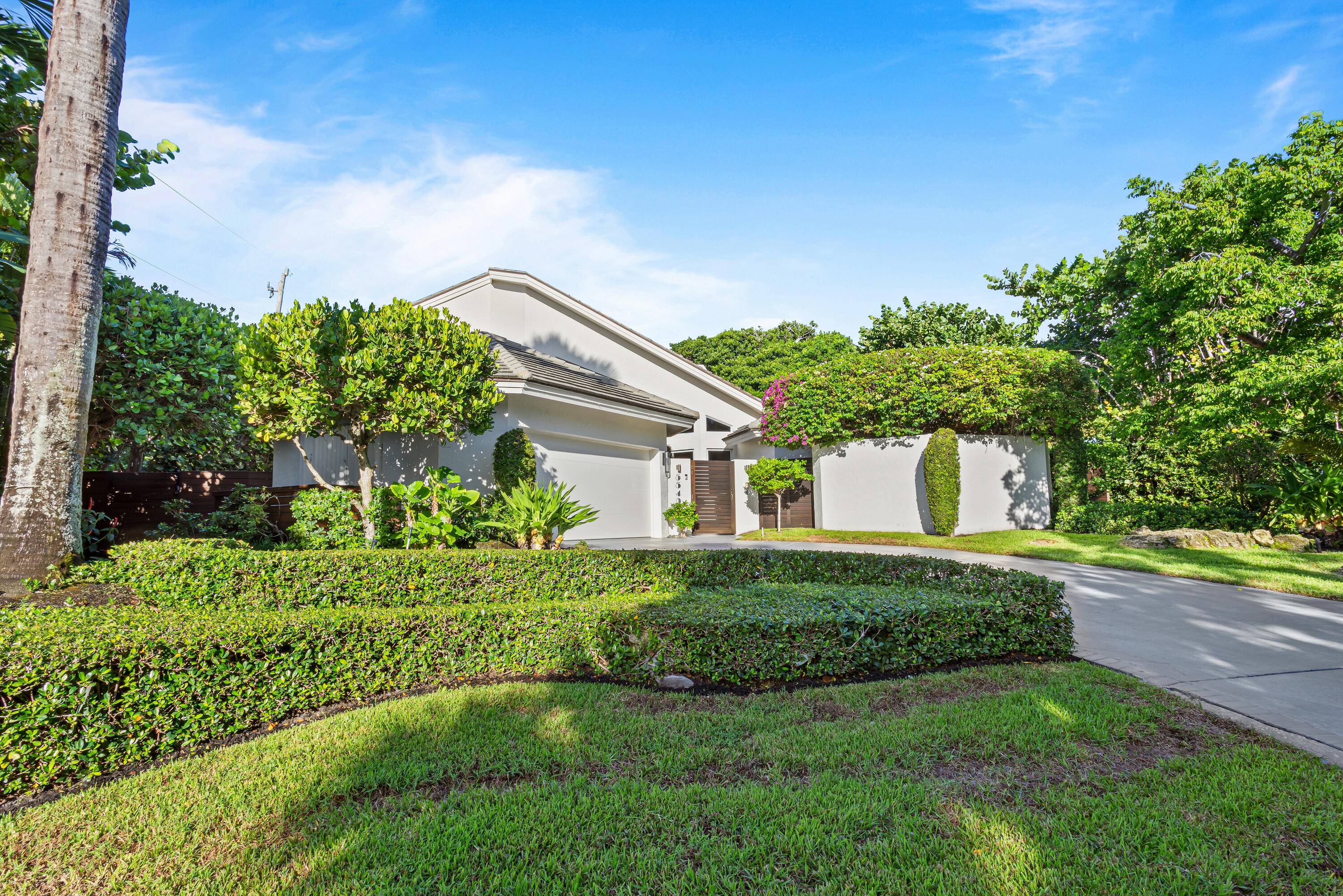 Lushly landscaped beach area four bedroom estate in prestigious Ocean Ridge is beautifully detailed with a modern vibe, a touch of Zen, and a sense of drama.