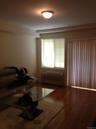 Living area with wood finished floors and radiator