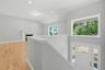 A large picture window above the entry door fills the foyer with an abundance of natural light.