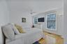 2nd floor twin bedroom featuring ceiling fan and television