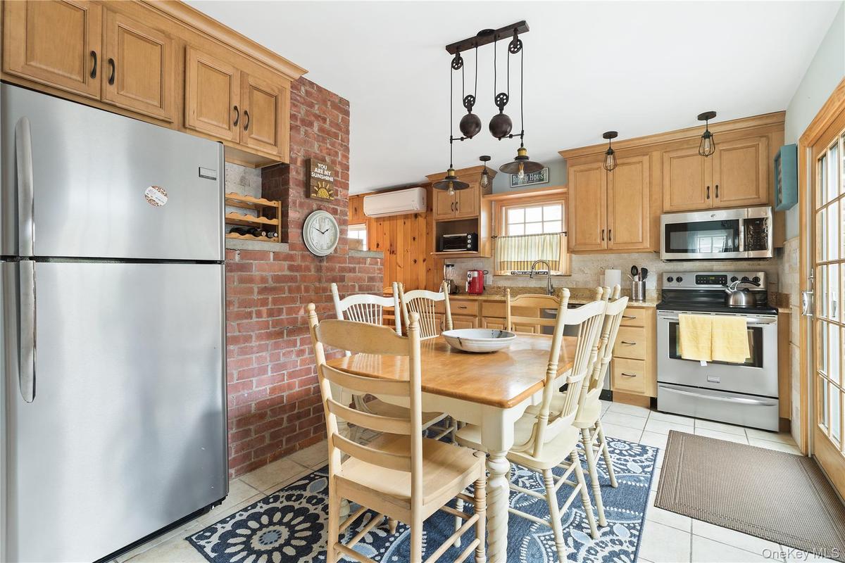 Dining area with light tile patterned floors and an AC wall unit