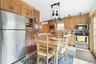 Dining area with light tile patterned floors and an AC wall unit