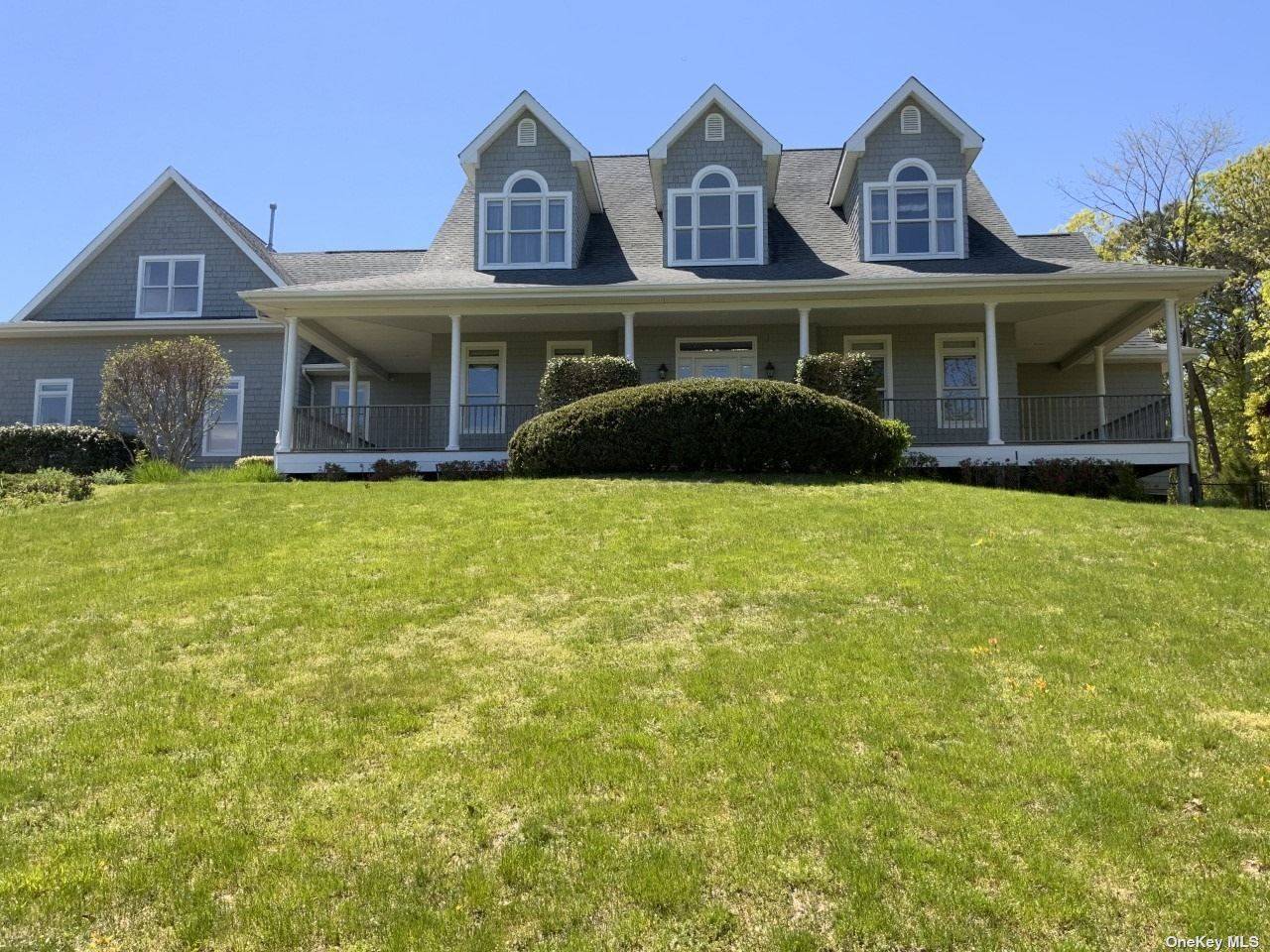 Light filled majestic 5 Bedroom, 4 bath home set up on a Hill in prestigious Southampton Pines.