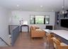 Living area with dark wood finished floors, healthy amount of natural light, and recessed lighting