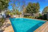 View of pool with a fenced backyard and a patio