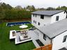 Back of property featuring a fenced backyard, a patio, outdoor dining space, outdoor lounge area, and view of scattered trees