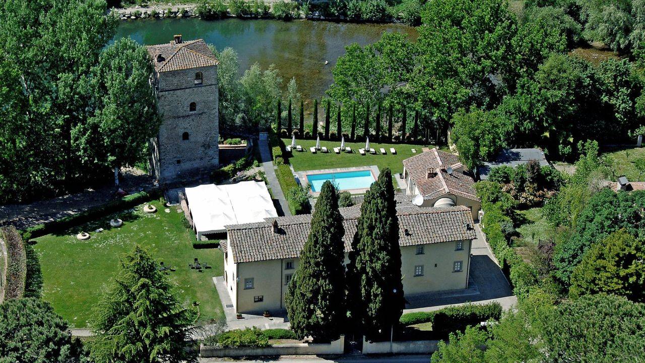 Luxury resort with 11 rooms, 4 suites, 17th-century villa, wellness centre, swimming pool and medieval tower for sale in Arezzo, Tuscany.
