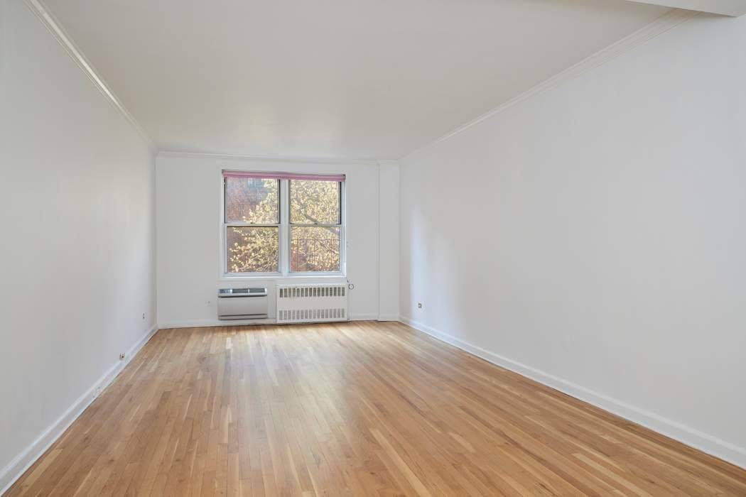 Sundrenched and spacious 1BR 1BTH, one block from Central Park, unobstructed south exposures overlooking pretty garden courtyard and townhouses.