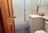Full bathroom featuring combined bath / shower with glass door, vanity, toilet, and tile patterned flooring