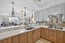 Spectacular kitchen w/ custom bleached walnut veneer cabinetry by renowned Chicago based millworker. Grain matches from top to bottom. Taj mahal quart