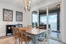 Dining room with sliding doors to a covered balcony overlooking Tampa Bay and the Skyway Bridge