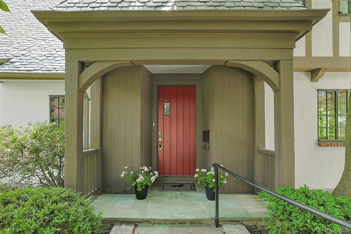 A close up of the stunning entry porch of this 1929 Tudor combining timeless architectural character with the state-of-the-art amenities and sophistic