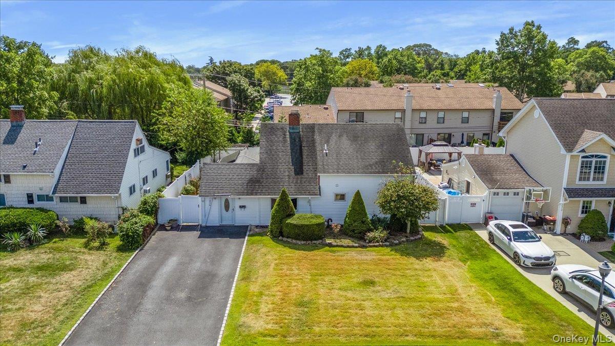 Aerial perspective of suburban area with a tree filled landscape