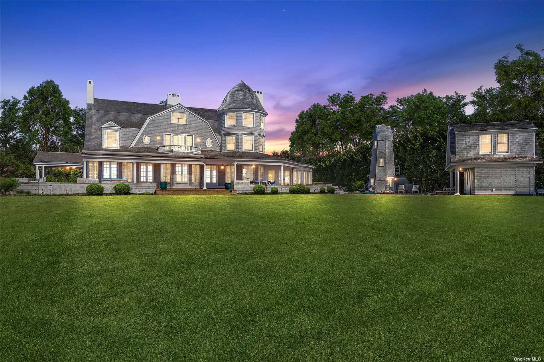 This majestic, one of a kind estate is set on 7 private, resort like acres south of Montauk Highway.