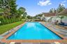 View of pool with a patio area and a lawn