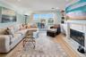 Living room featuring recessed lighting, light wood finished floors, visible vents, crown molding, and a fireplace