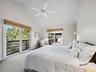 Another large guest bedroom awaits with a private juliette balcony and also deck access.