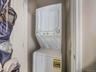 Washroom featuring stacked washer and clothes dryer